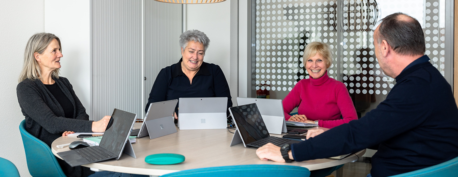 Meerdere mensen achter een computer op kantoor